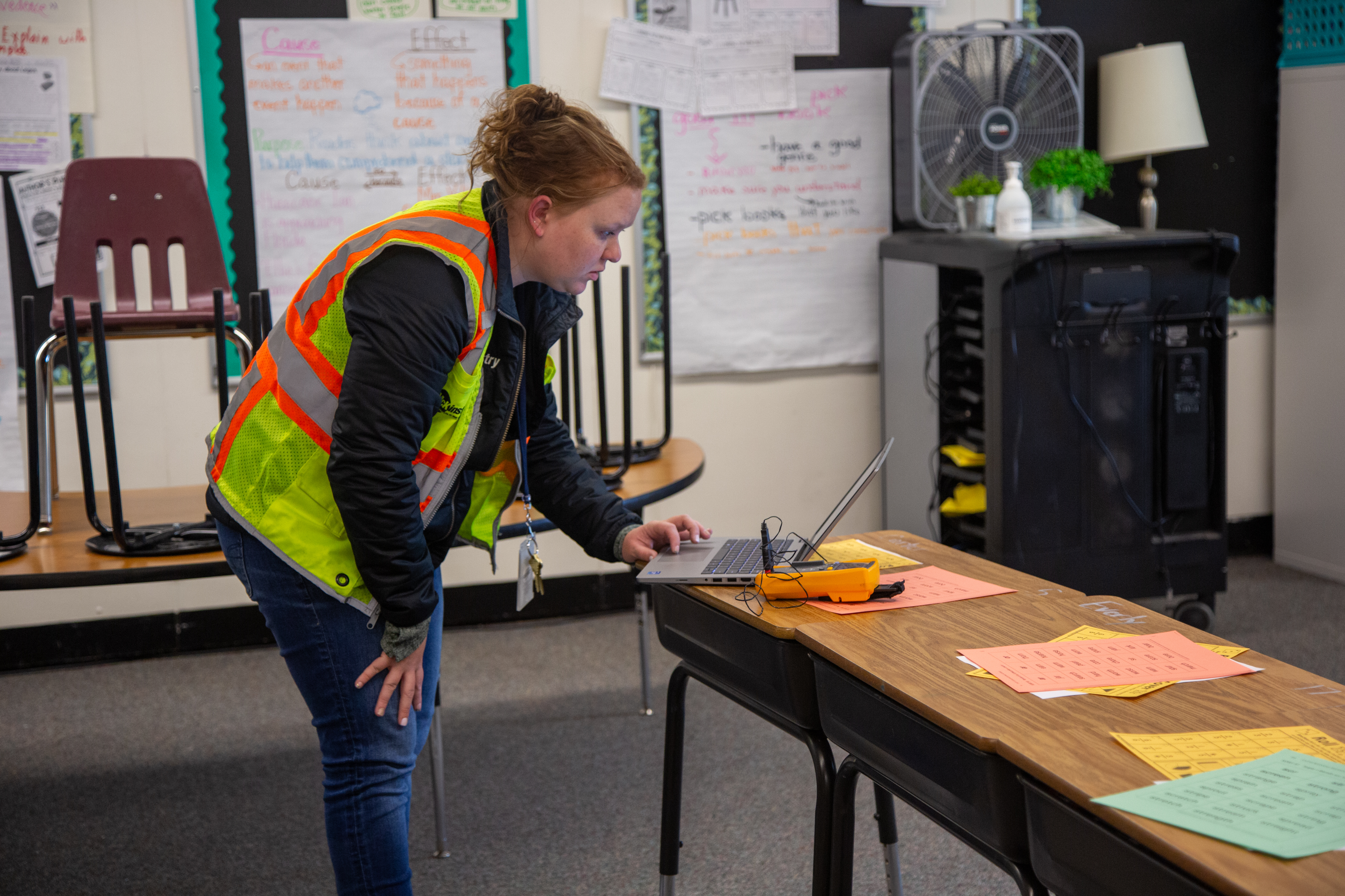 A McKinstry staff member collects data in an elementary school. 