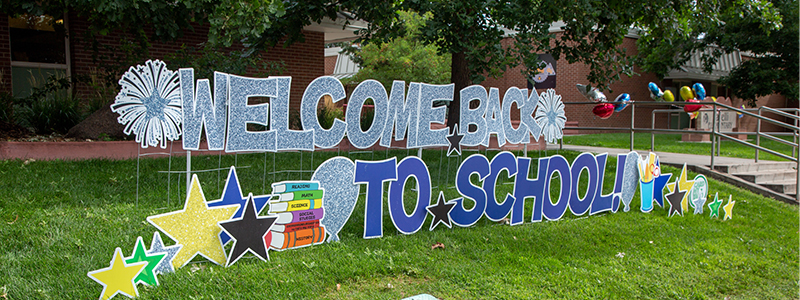 Welcome back sign in front of a school. 