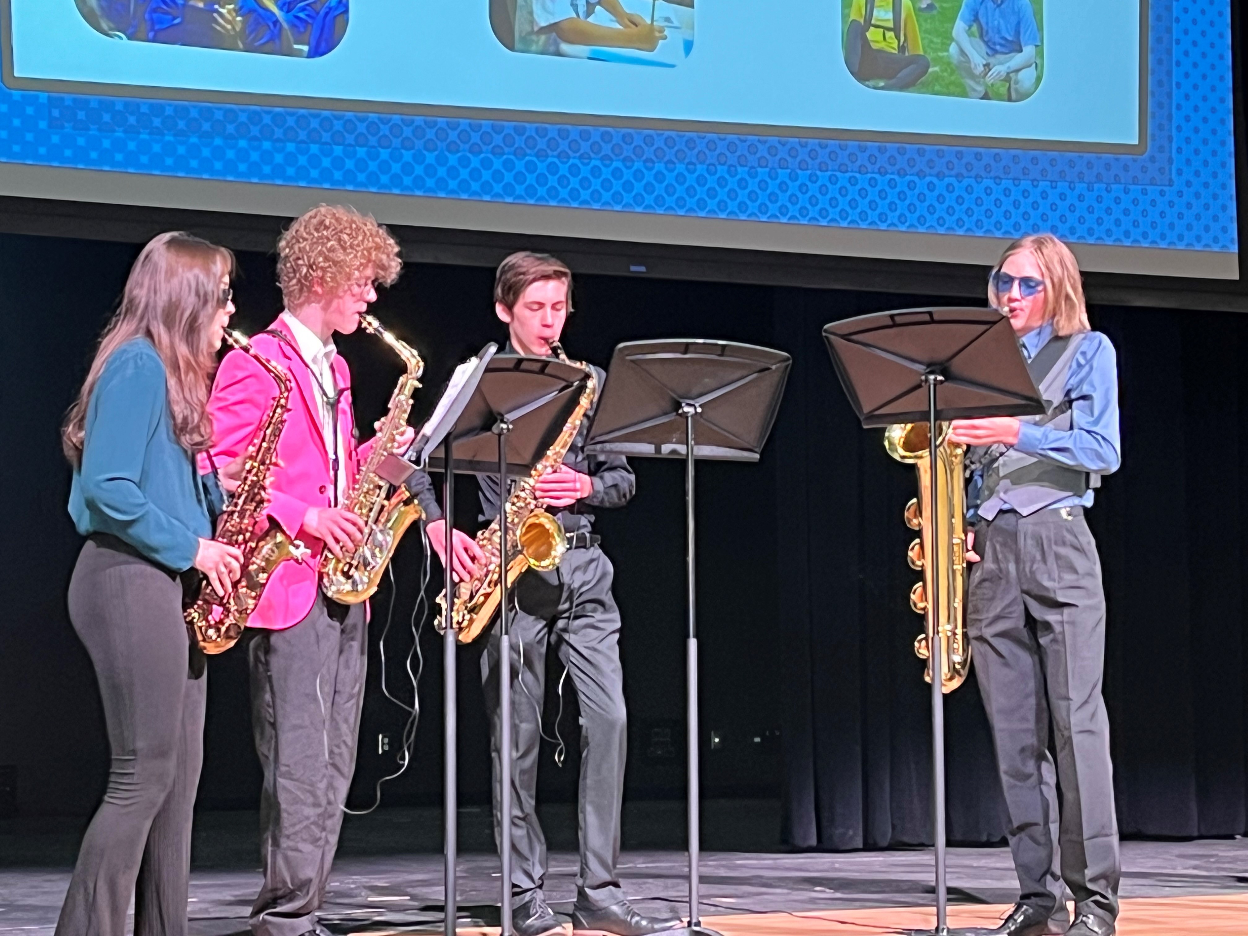 The FCHS saxophone quartet play on stage.