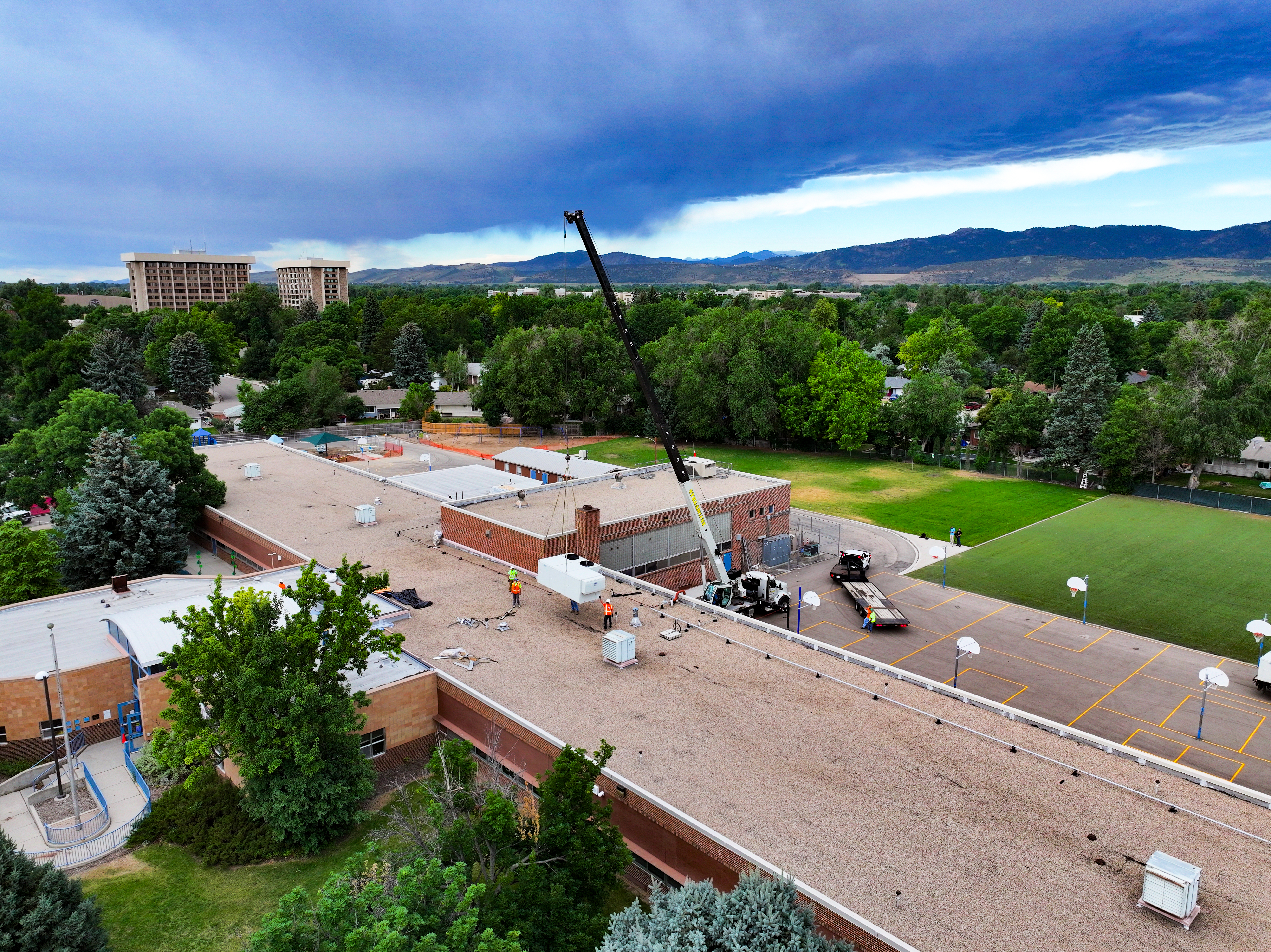 PSD staff work on the roof of Dunn Elementary to replace an HVAC system. 
