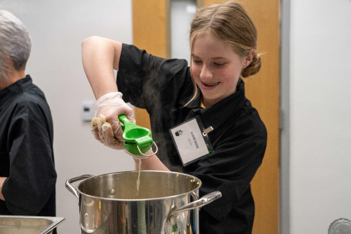 A student mixes something up during the cooking contest.