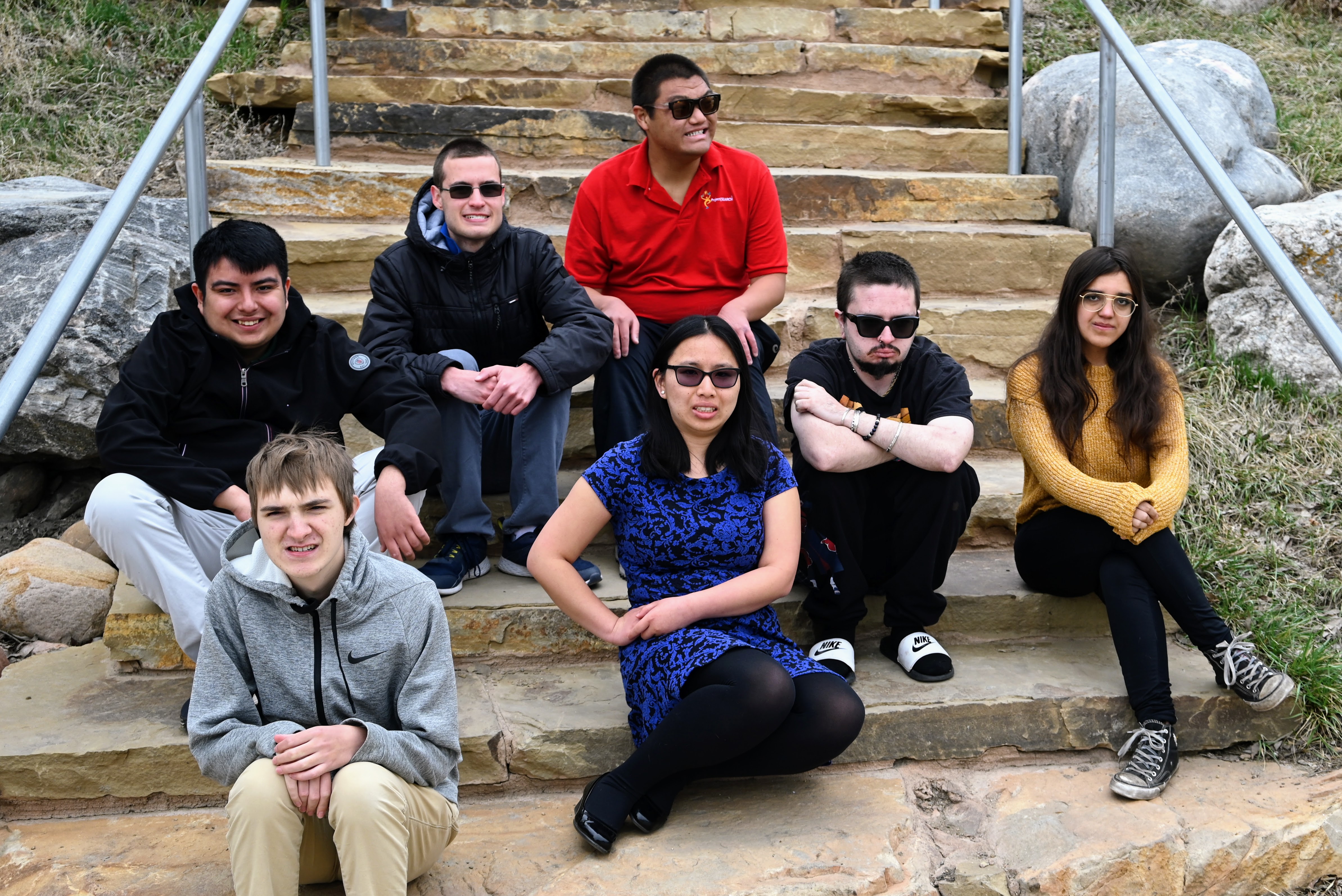 Project Search graduates sit outside on steps together.