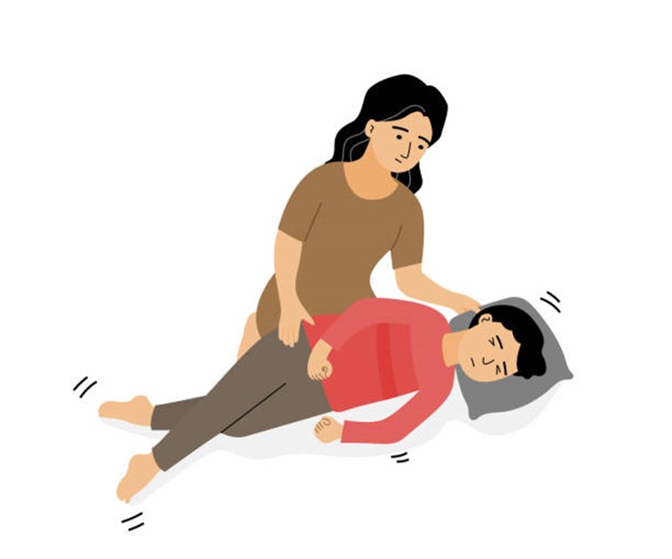 A drawing of a mother tending to a child having a seizure.