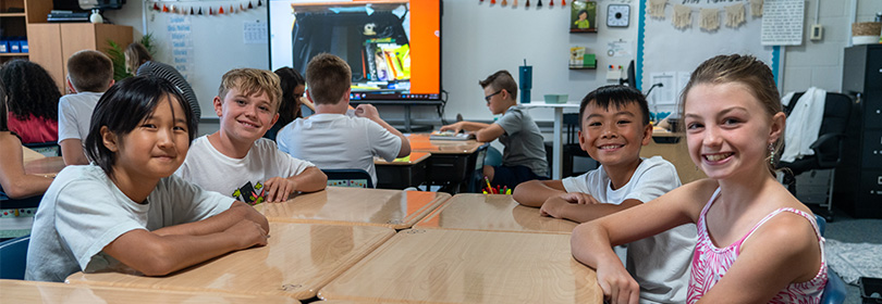 Elementary students sitting at desks. 