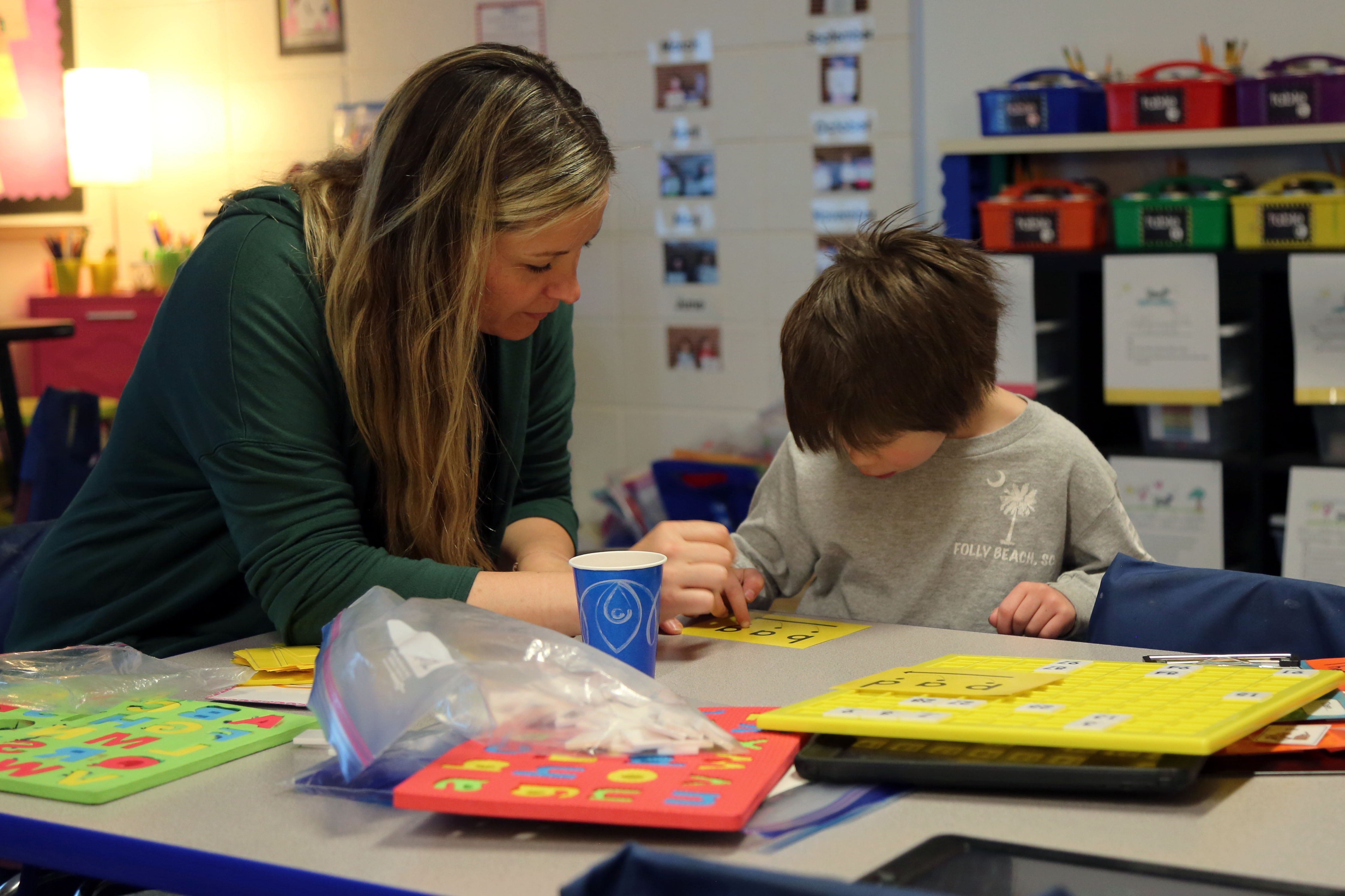 A PSD teacher works with a kindergarten student.