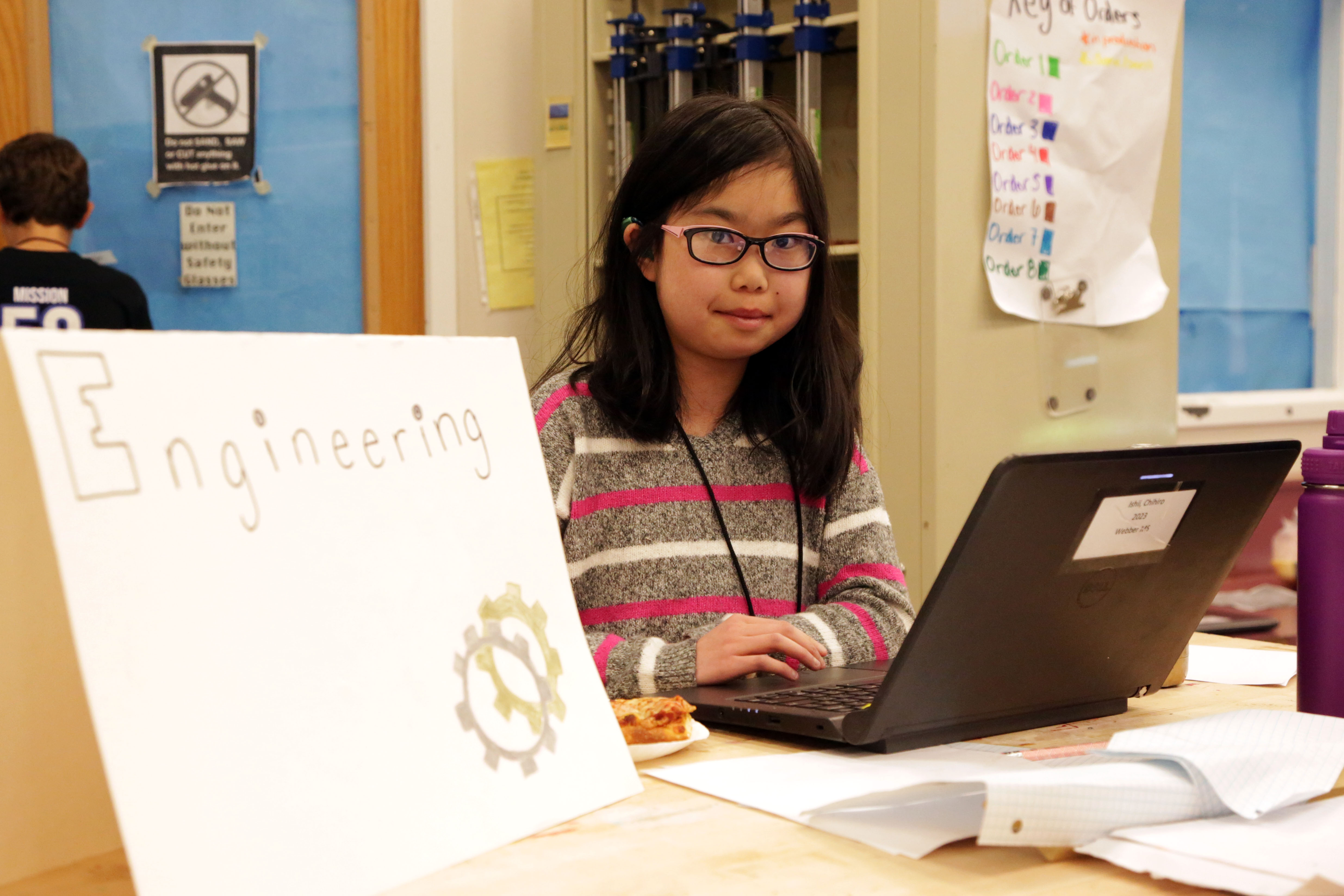 A student engineer on the WAVE team works at her computer.