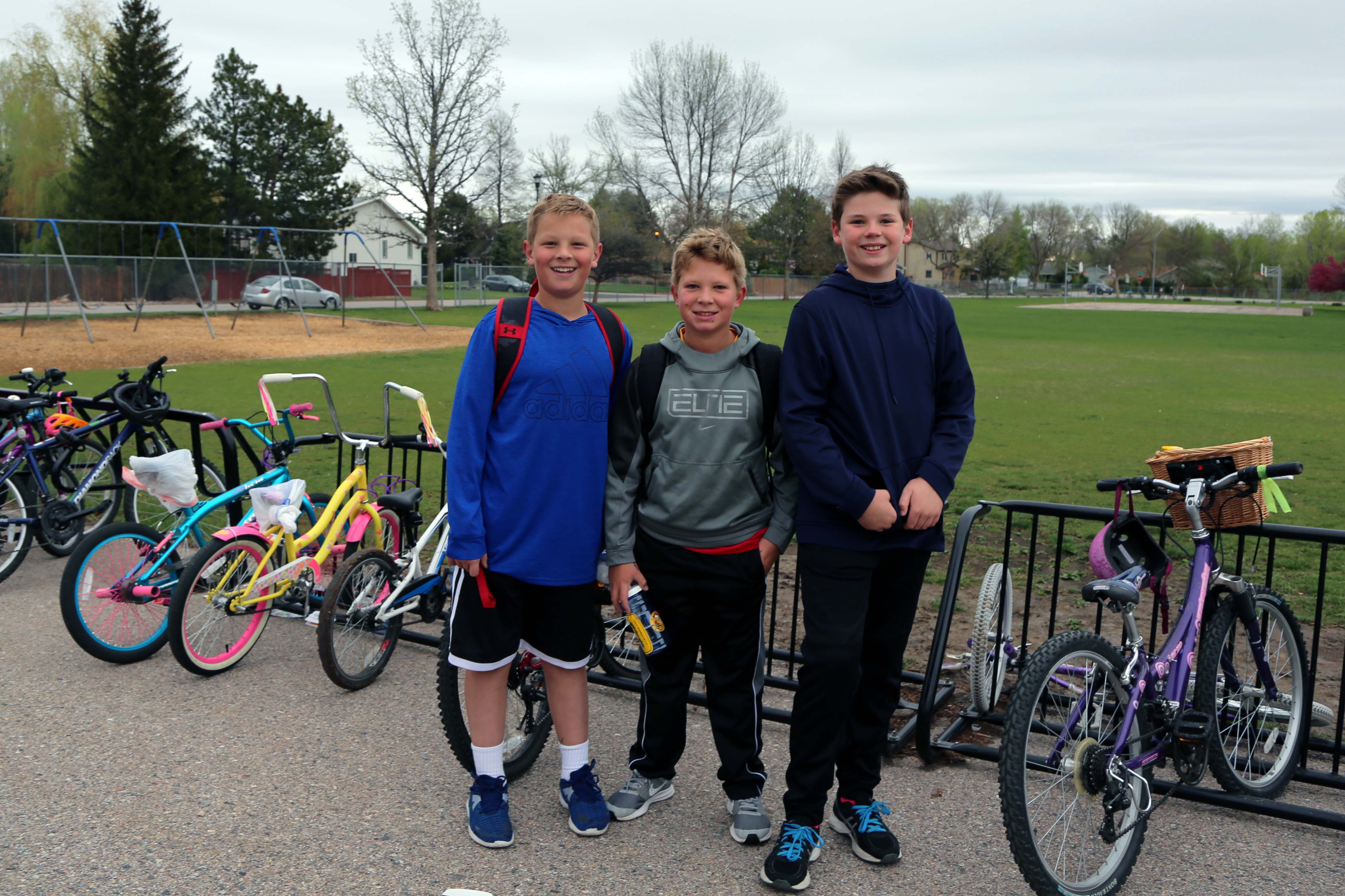 Three boys stand with their bikes on Bike to School Day.
