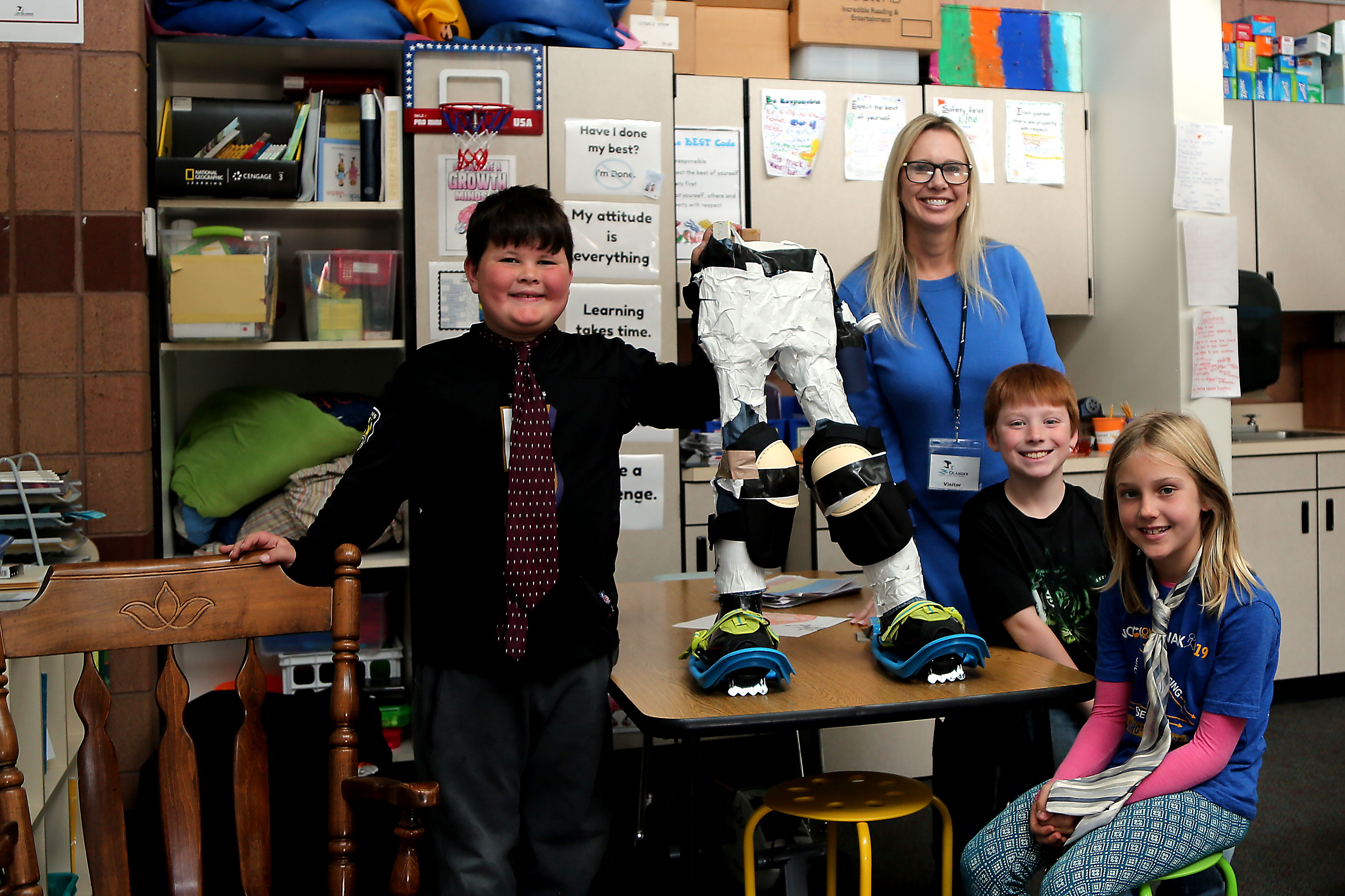 Olander Elementary students show off their specialized boots for firefighters that they invented. 