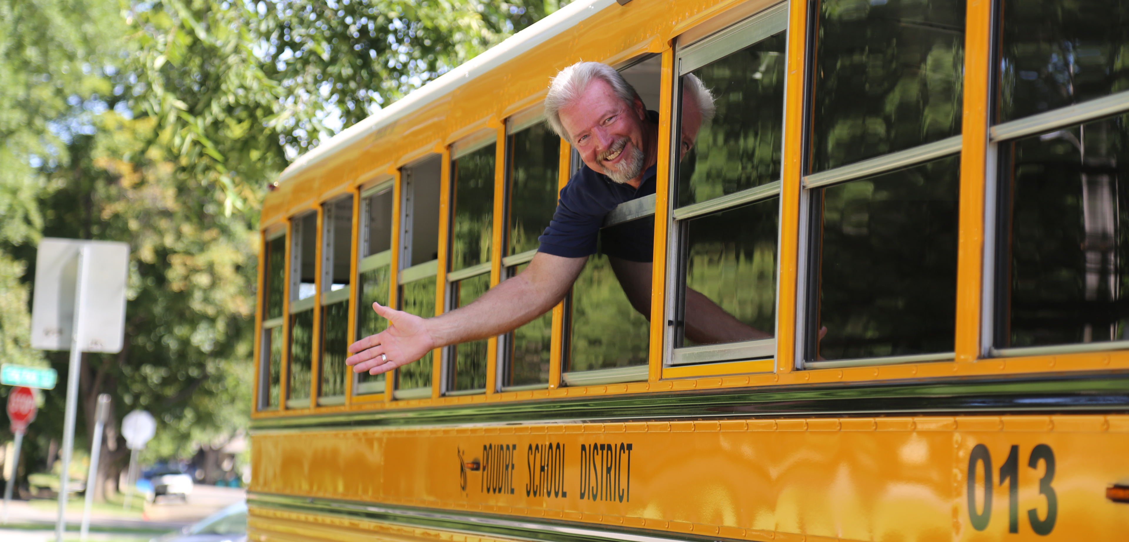 A PSD bus driver waves from a PSD bus.