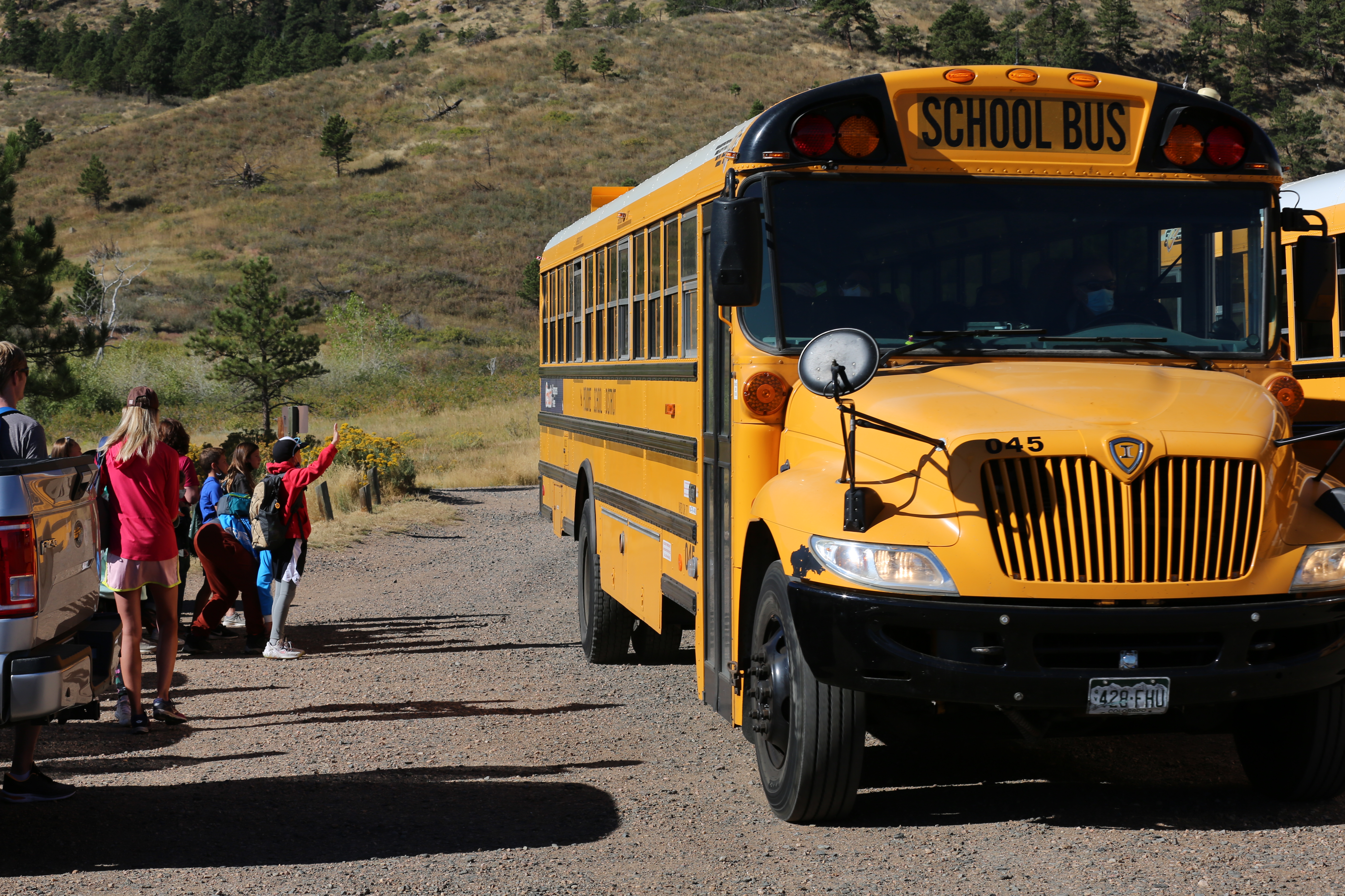 Kids waiting outside as a PSD bus pulls up. 