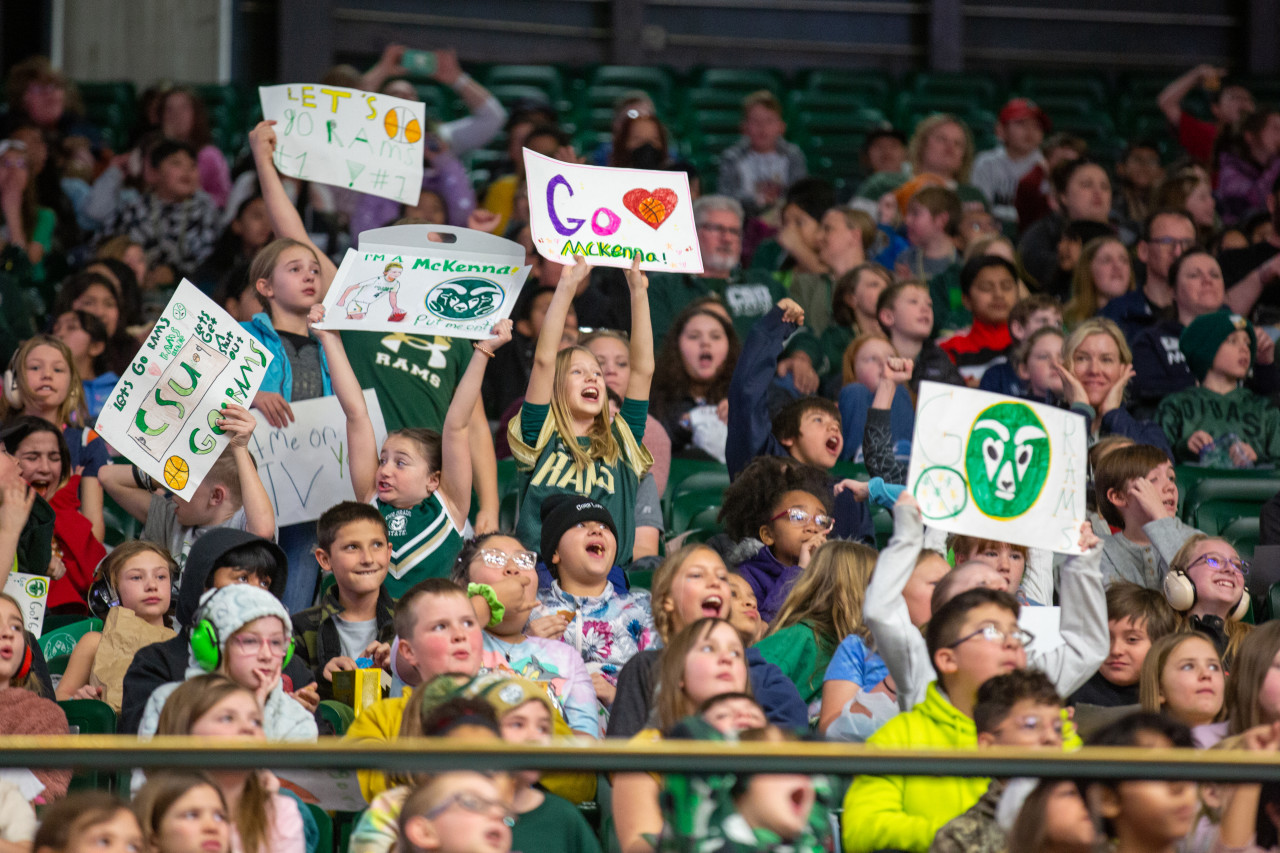Fourth and fifth graders cheer at a CSU basketball game on Education Day. 