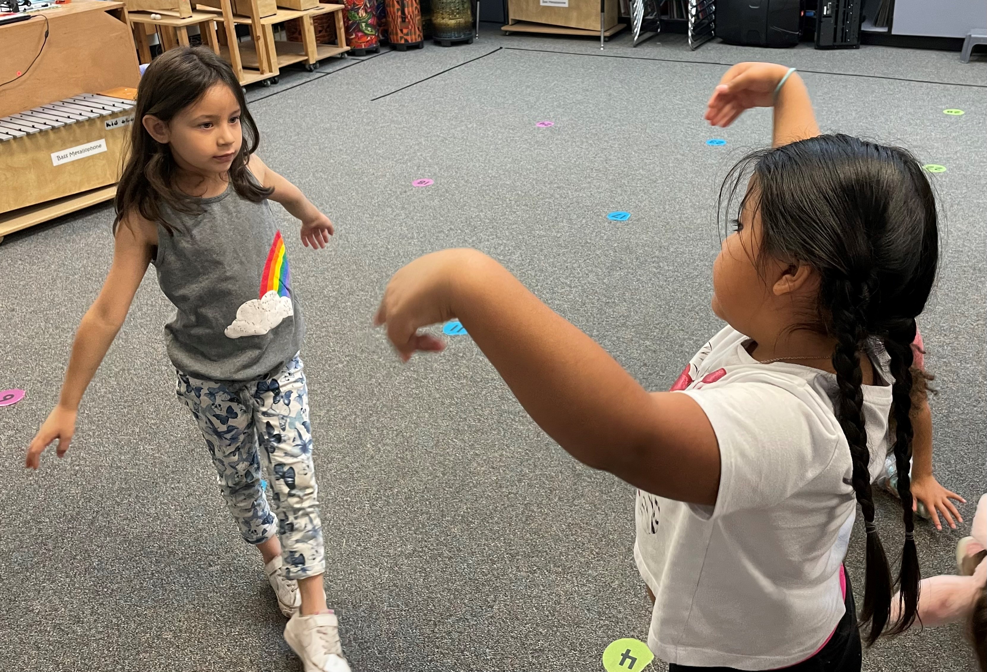 Two young elementary dancers with graceful arms.