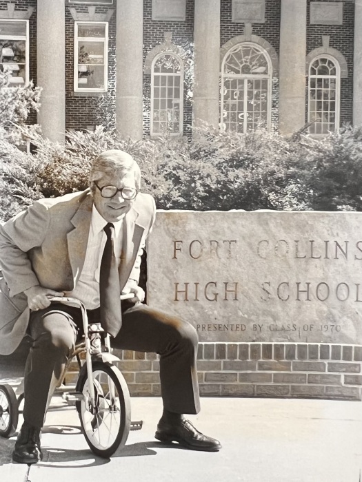 Armon Johannsen sits on a tricycle in front of Fort Collins High School in the 1970s. 