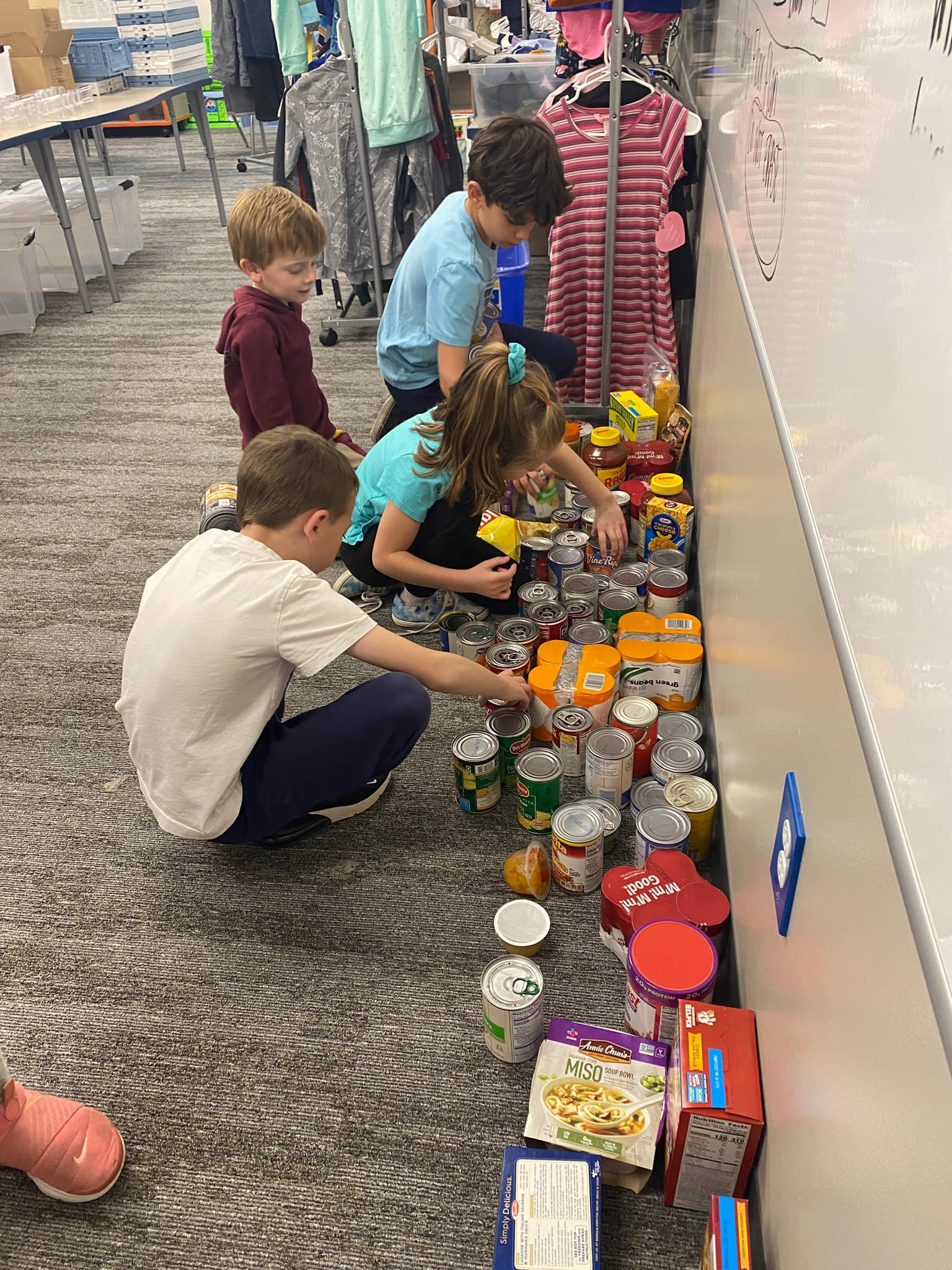Bamford Elementary students line up cans. 