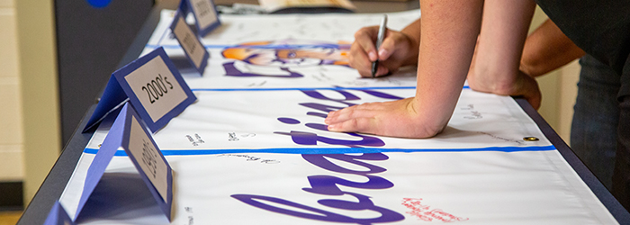 Close up of hands signing a celebration sign for Beattie Elementary. 