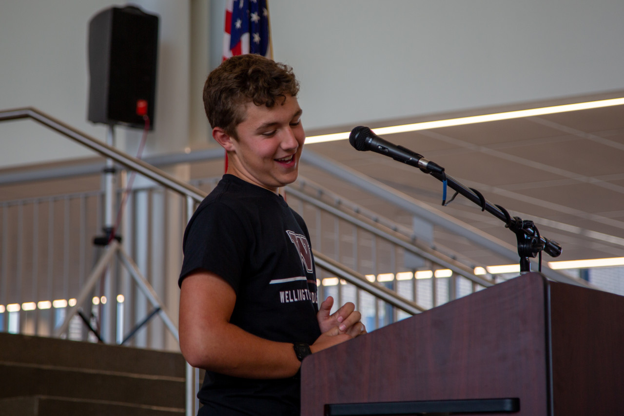 Tobin Phillips, Wellington student, speaks from a podium during the celebration. 