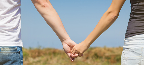 Two students holding hands.