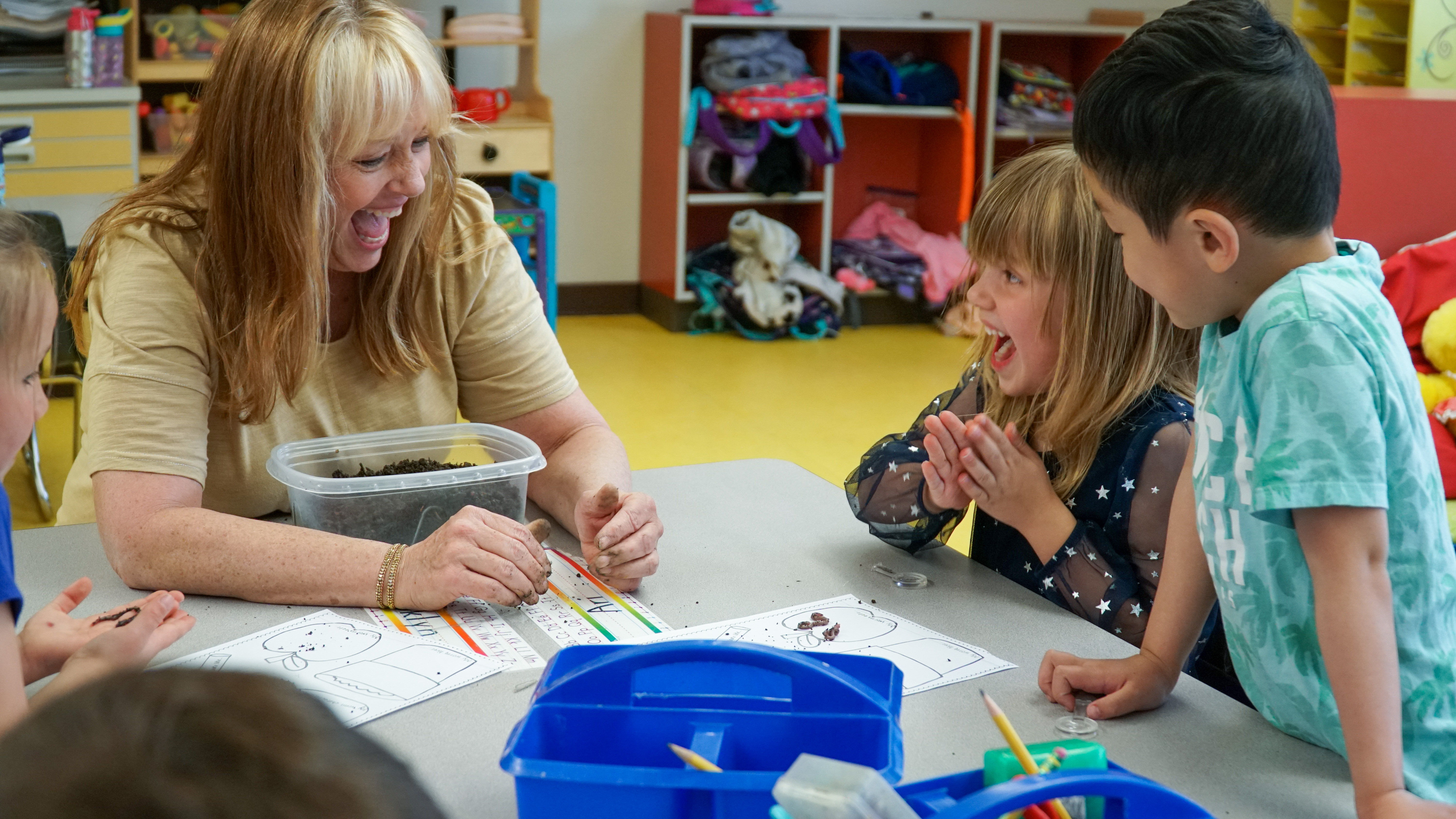 Bacon Elementary kindergarten teacher Suzanne Biedscheid laughs looking at worms with her students. 