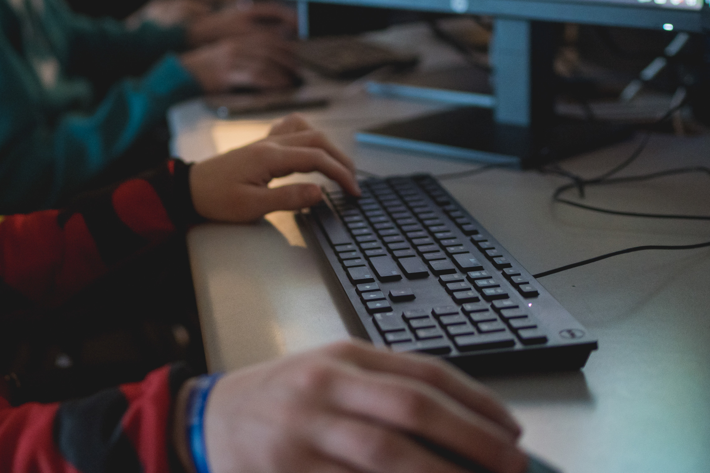 Hands and a keyboard to indicate working on a computer. 