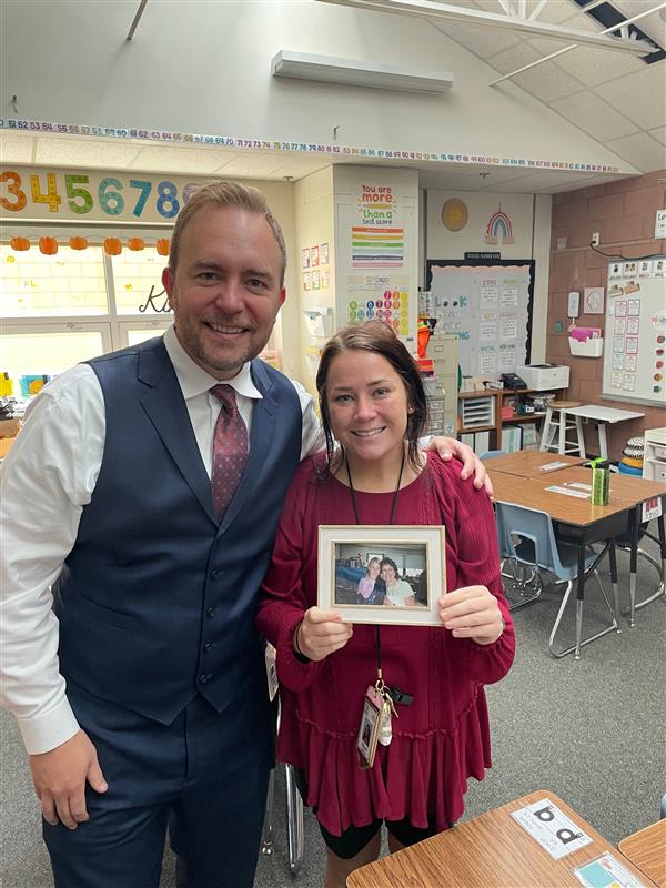 Morgan Barker, Laurel Elementary teacher, holds a photograph with Superintendent Brian Kinglsey 