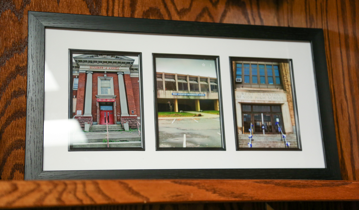 Superintendent Brian Kingsley's framed photographs of the three schools he attended growing