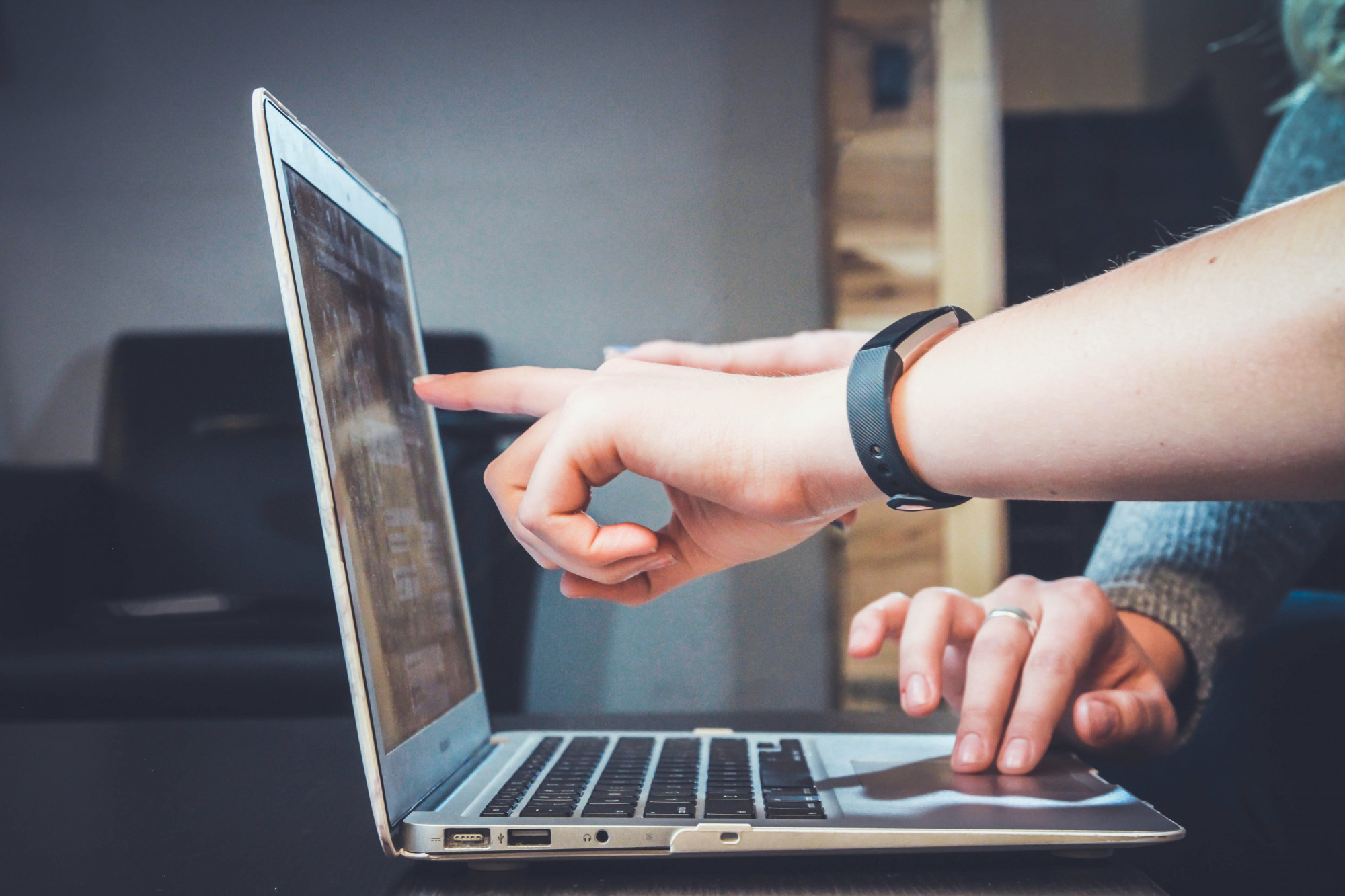 two students working on a laptop