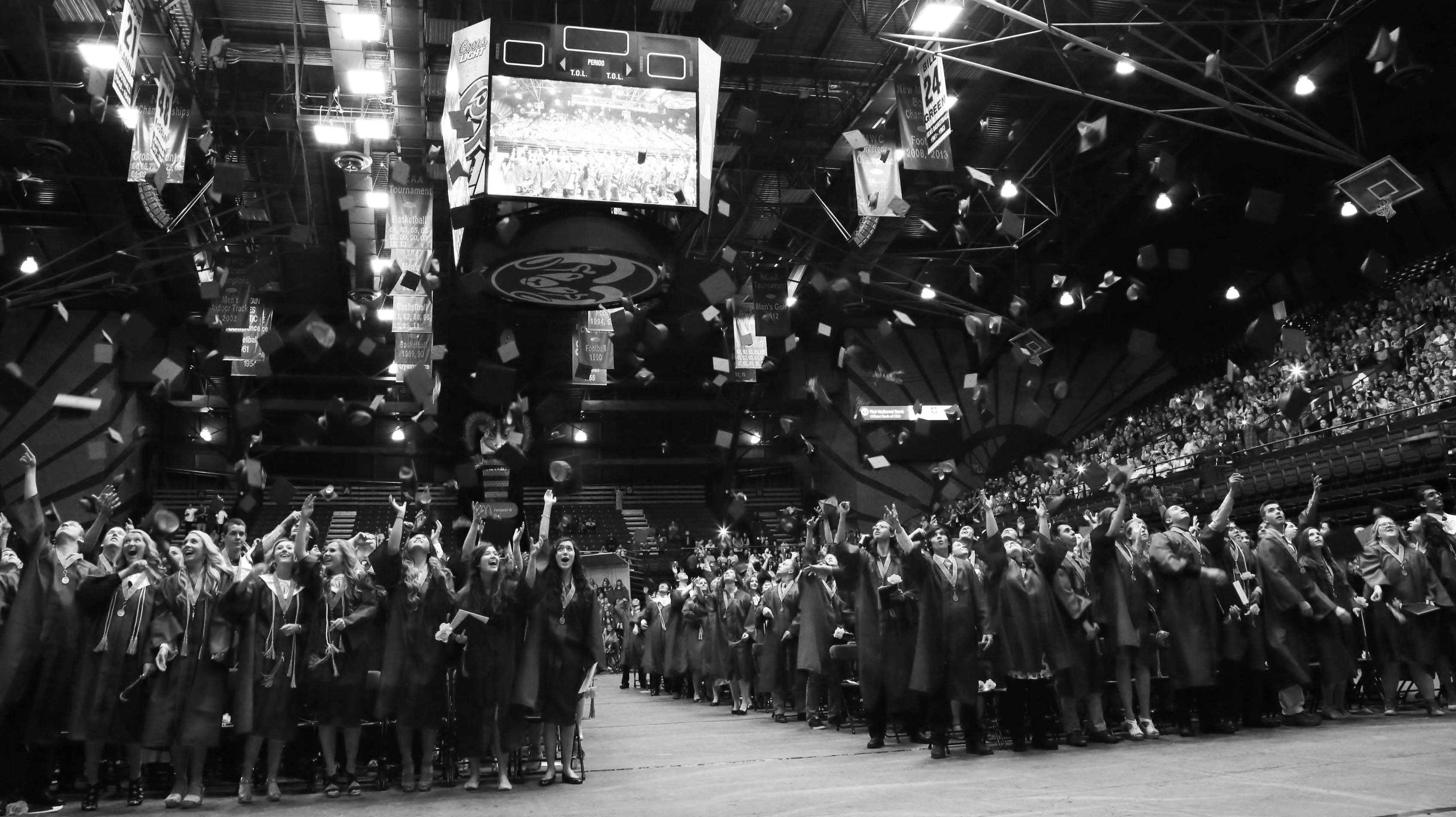 Students celebrate graduation by throwing their caps