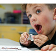 A kindergartener is amazed by his worm.