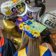 Graduation balloons and a decorated grad cap