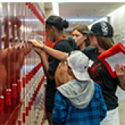 A new middle school student gets help opening his locker.