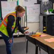 A McKinstry staff member collects data in an elementary school. 