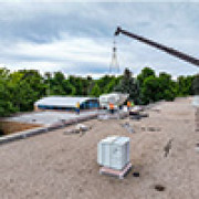 A crane with an AC system on the roof of Dunn Elementary. 