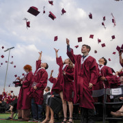 graduates of Wellington throw their caps into the air