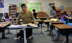 Kids sitting at desks in a classroom.